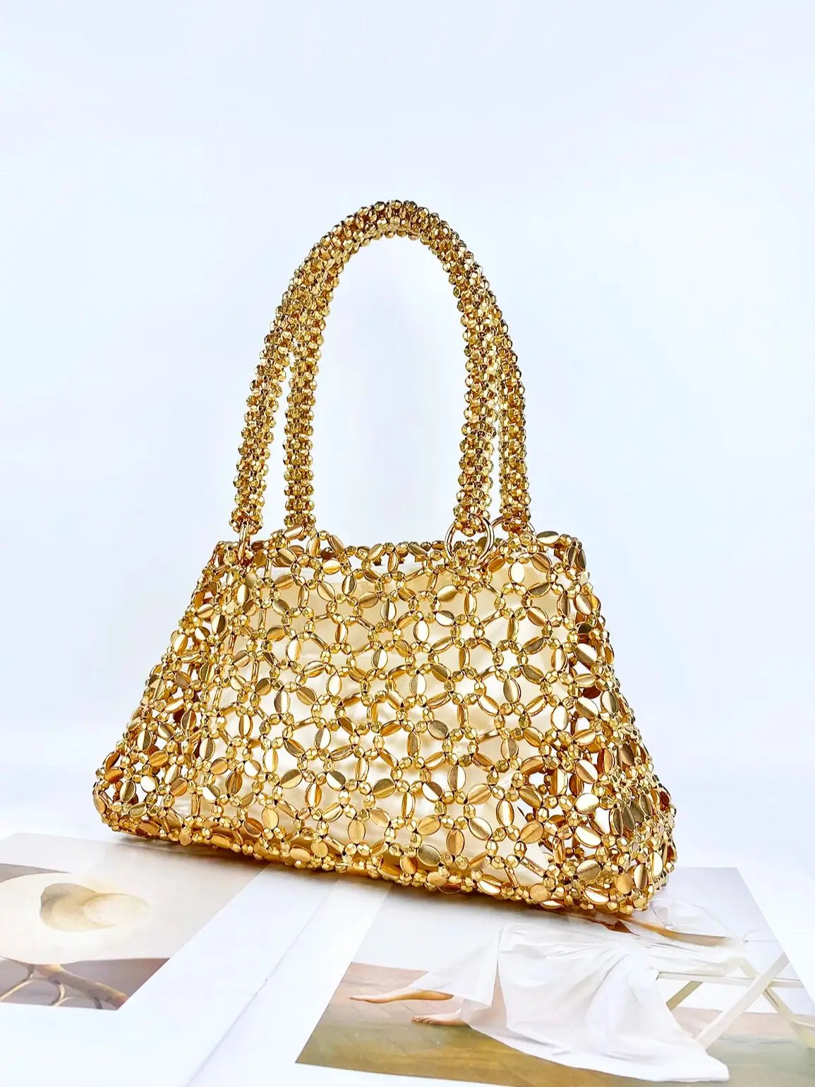 Korean version personalized woven hollowed out high aesthetic ceiling versatile handbag shiny handmade pearl tote underarm bag